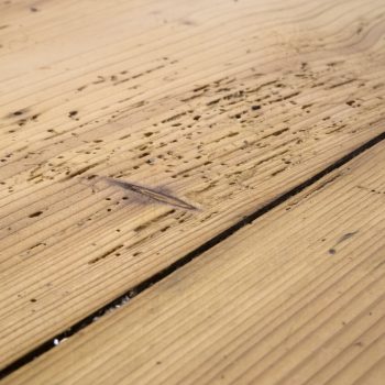 Old plank floor damaged by borer, woodworm